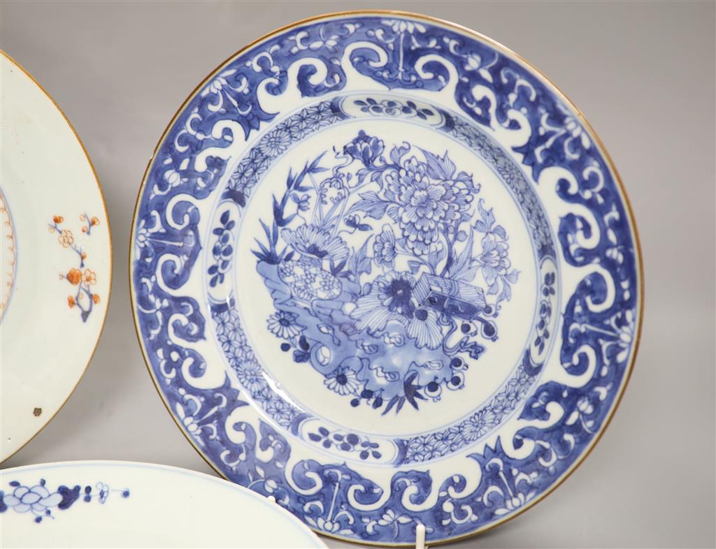 Three Chinese Qianlong plates, two blue and white, the third in Imari palette, diameter 23cm